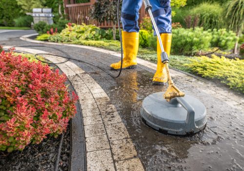 Garden Worker Pressure Washing Decorative Bricks Garden Paths. Garden Keeper Job.